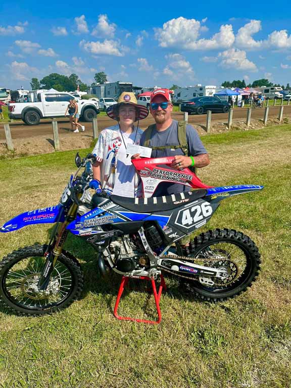 Josh Stevenson of PPI hands Grant a sponsor check at Redbud 2025.